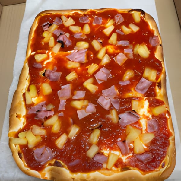 A rectangular Romano's Pizzeria pizza with tomato sauce, ham, and pineapple chunks.