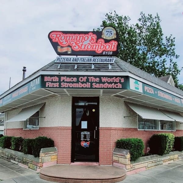 Exterior of Romano's Stromboli, a pizzeria and Italian restaurant, with a sign proclaiming it the "Birth Place Of The World's First Stromboli Sandwich."